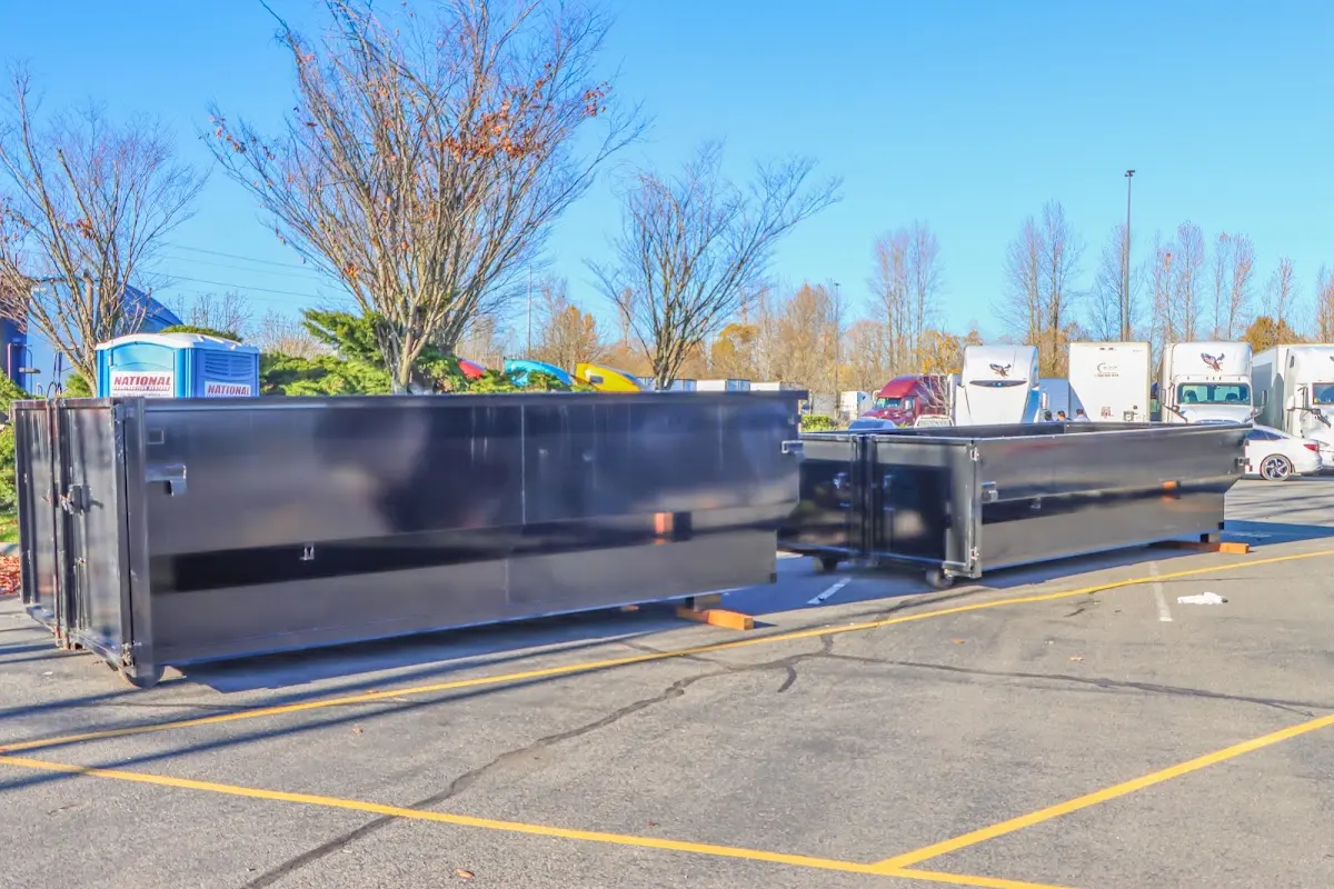 Professional dumpster rental service with roll-off container on residential driveway in Cudahy